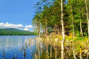 Obraz premium Summer mountain forest landscape - the Turgoyak lake and the coast of the St Faith Island in Southern Urals, summer picturesque view of Russian nature