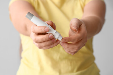 Woman with diabetes taking blood sample, closeup