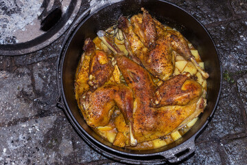 Crispy browned roast chicken in the iron cast dutch oven.