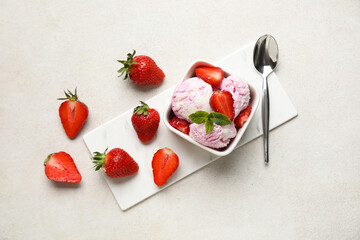 Square bowl of strawberry ice cream with mint, berries and spoon on white grunge  table