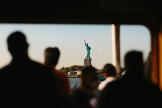 Silhouette view of Liberty Statue through a ferry window in New York