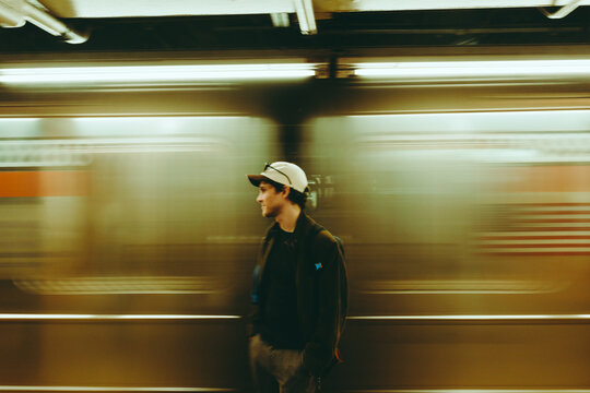 Urban commuter standing in front of speeding subway train in New York