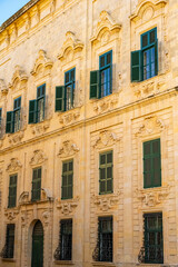 View of old building with windows, balconies in city. Republic of Malta, the picturesque city of Valetta, Malta.