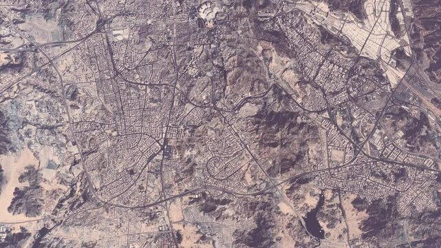 Aerial high altitude view of Mecca Saudi Arabia is considered the holiest city in Islam also showing Islams holiest site Kaaba in Al-Masjid Al-Haram the Sacred Mosque and the Kaaba 4k animation 