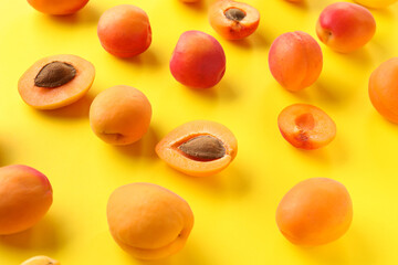 Sweet apricots on yellow background