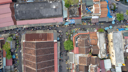 Aerial view of bustling urban market street, tropical cityscape, commerce and daily life atmosphere Hoi An