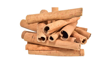 A pile of dry cinnamon sticks lies on a PNG background