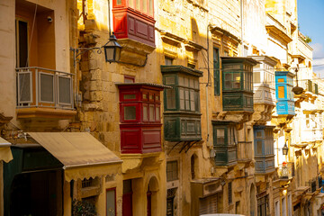 Typical narrow streets with colorful balconies in VallettaTypical narrow streets with colorful balconies. Narrow streets with colourful window boxes in Valetta, MaltaTraditional Maltese balconies in V