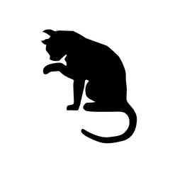 Black silhouette of a cat licking its hand