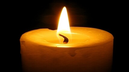 A single lit candle in the dark.  Warm, inviting, and peaceful ambiance. Perfect for meditation, relaxation, or spiritual themes.