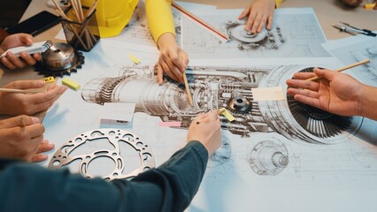 A dynamic group collaboration captures hands engaged in drawing details of a jet engine, showcasing teamwork and creativity in engineering design projects. SACTR