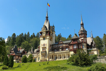 Famous Peles Castle in Sinaia, Romania, a stunning royal landmark surrounded by scenic Carpathian...