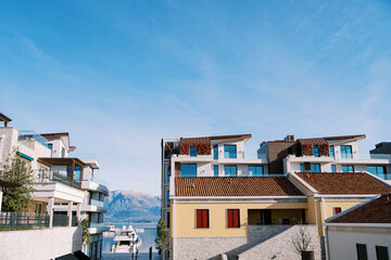 Two-story houses with terraces on the seashore against the blue sky