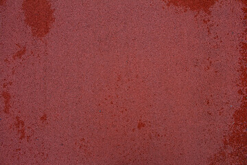 red rubber coating on the ground with water droplets