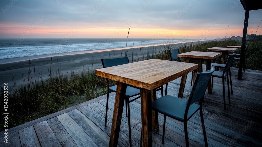 Aufkleber wooden table and chairs are set up on a beach, overlooking the ocean. the chairs are blue and arrang