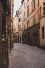 The architecture and narrow streets of the city of Siena in Italy