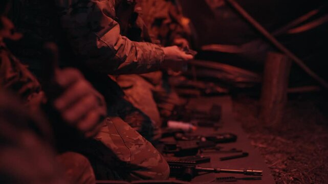 Ukrainian soldiers clean weapons in the trenches