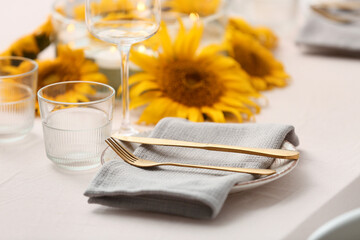 Table setting with beautiful sunflowers. Closeup