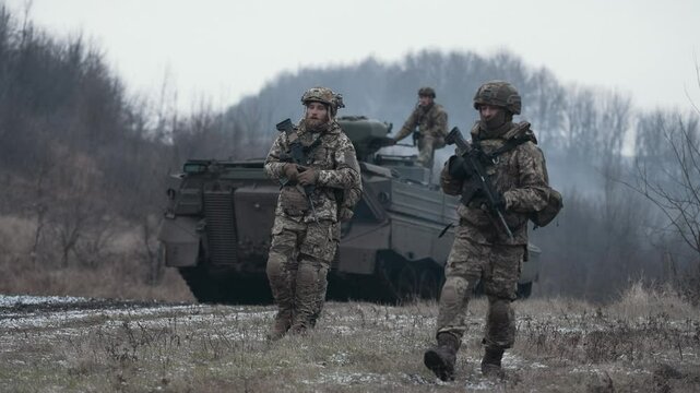 Ukrainian infantrymen move with armored vehicles