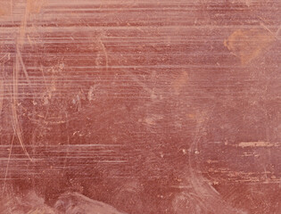 Scratched copper with a deep brownish-red color as background