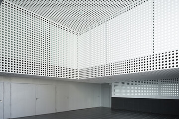 Modern auditorium interior with geometric perforated walls