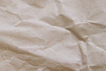 Crumpled craft paper background. Crumpled craft paper texture or paper background. Background with copy space. Top view. Space for text. Close-up view of crumpled brown paper texture