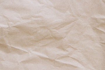 Crumpled craft paper background. Crumpled craft paper texture or paper background. Background with copy space. Top view. Space for text. Close-up view of crumpled brown paper texture