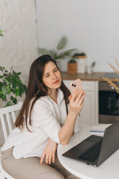Nutritionist consulting remotely on smartphone at home office
