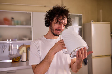 Unboxing a stylish, modern kettle designed for use in a bright, contemporary kitchen space