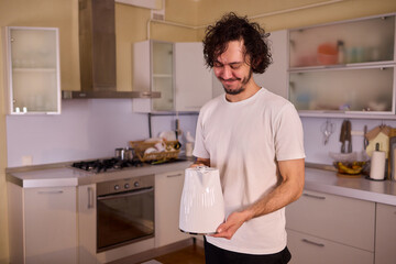 Unboxing a stylish, modern kettle designed for use in a bright, contemporary kitchen space