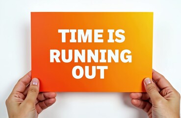 Hands holding orange card with text Time is Running Out. Concept of urgency, important deadlines. Useful reminder in business, education, personal project. Metaphor of limited time. Act now or never.