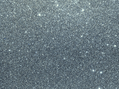 Silver sparkle background. Silver glitter background. Metallic gray glimmer. Abstract twinkle texture. Glitter surface. Glimmer layout. Holiday layout. Diamond luxury surface. Celebration background.
