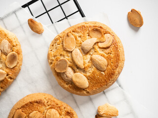 Flat lay of an almond cookie on a cooling tray with a white background