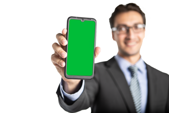 Smiling businessman holding smartphone with green screen for editing