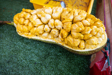 jackfruit on street food stand in market, ripe jackfruit peeled tropical fruit fresh from jackfruit...