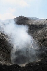Great view of Mount Bromo crater activity with smoke and steam coming out
