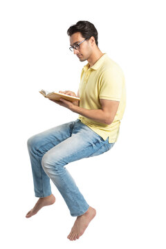 Passionate student sitting and reading a book	