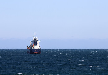 Large cargo ship above the horizon line.