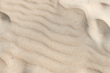 Wave marks on the sand of the beach.