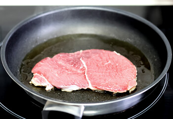 Frying beef fillets in the pan.