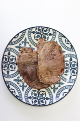 Beef steaks cooked on a plate. 