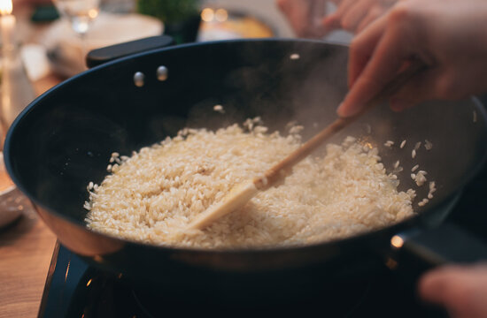the process of cooking risotto in a frying pan