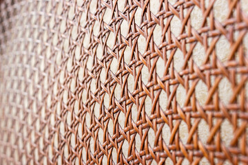Weave pattern of rattan furniture close-up. Abstract background. Selective soft focus