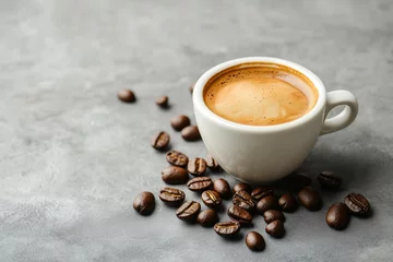 Gordijnen A cup of hot espresso and coffee beans on a grey background © Andrey