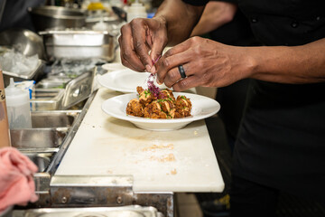 chef preparing food, appetizers and adding garnish