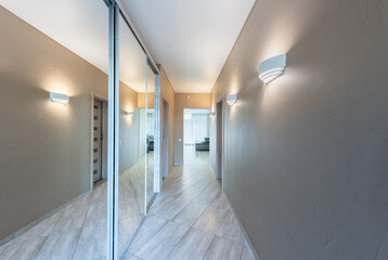 Bright Modern Home Hallway Interior With Wooden Doors and Neutral Wall Colors