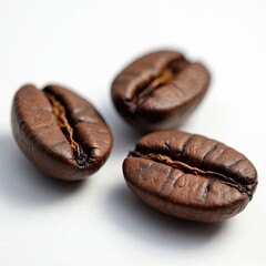 Obraz premium Three roasted coffee beans on a white background. Brown color. Dark, aromatic caffeine texture. Fresh pile of natural espresso seeds. Macro close-up. Hot drink, coffee beverage.