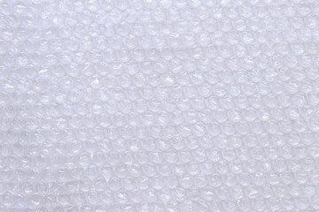 Air bubble wrap, top view. Transparent bubble wrap on light background. Close-up of bubble wrap. Background. Copy space. Polyethylene bubble wrap for packing and transporting fragile items