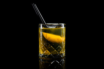 Cocktail Rusty Nail in a glass on a black background
