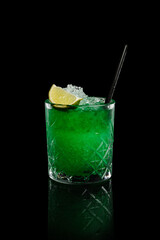 Green Vesper cocktail on a black background